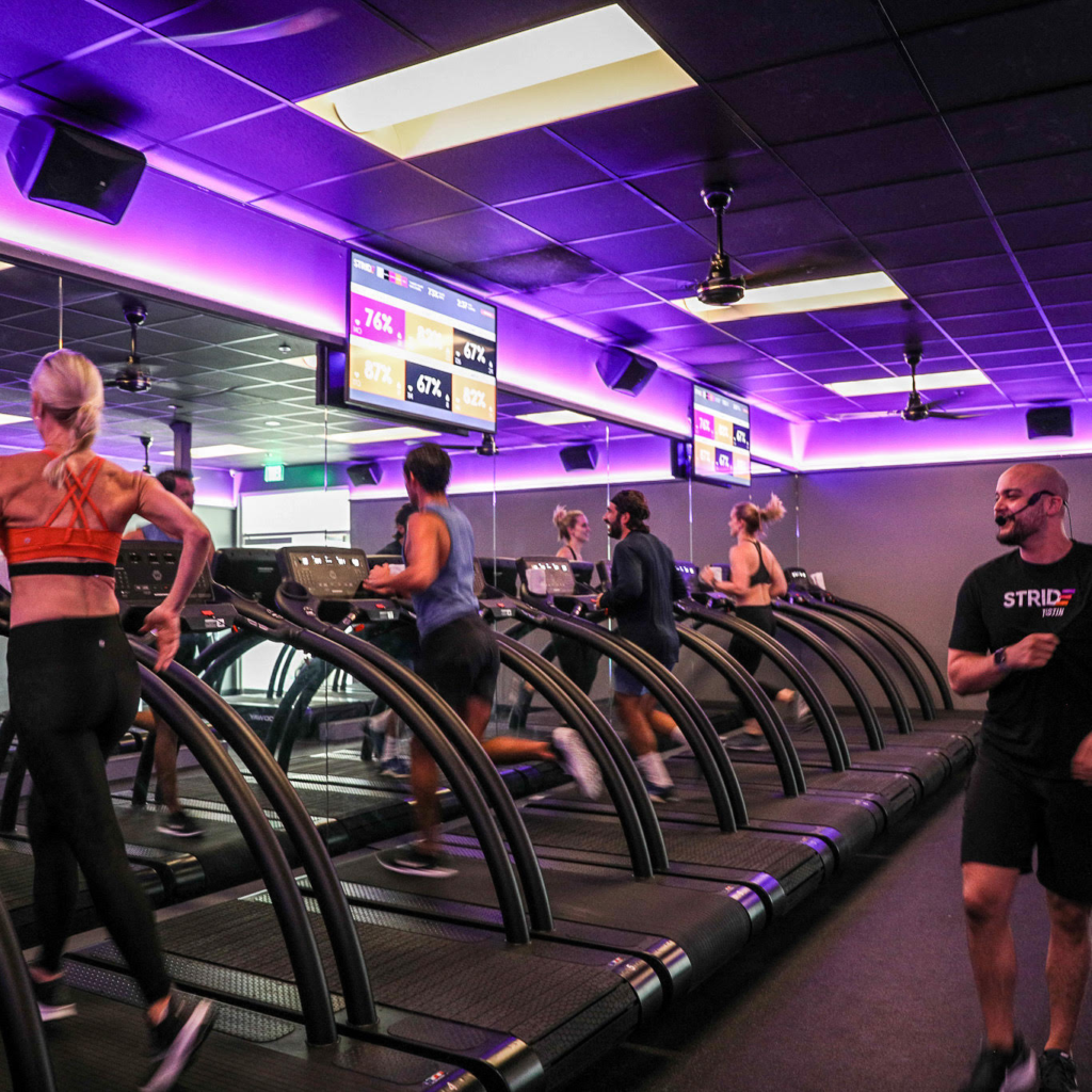 Members running on treadmills at Stride