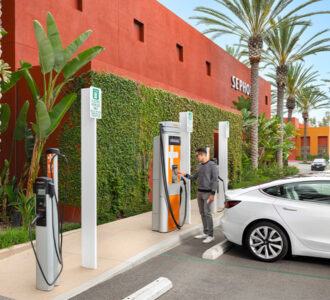 Person charging car at electric vehicle charging station at Sephora at The Market Place in Tustin and Irvine